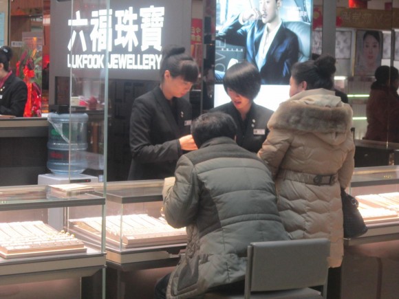 圖片2:專櫃職員細心為顧客介紹飾品_副本